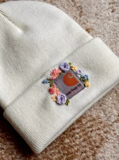 a white beanie with flowers on it