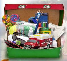 an open green box filled with school supplies