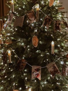 a christmas tree with pictures and candles on it