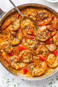 a skillet filled with shrimp and tomatoes