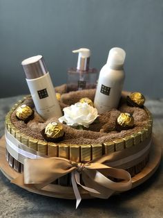 a wooden tray with some items in it on top of a table next to a bottle of lotion