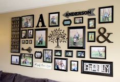 a wall with many family photos and pictures on it, all hanging up against the wall