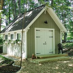 a small shed with a porch and steps leading up to the front door is shown