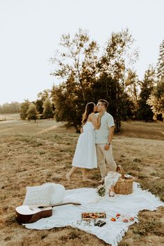 a man and woman standing next to each other on top of a field