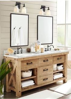 a bathroom with two sinks, mirrors and towels on the counter top in front of it