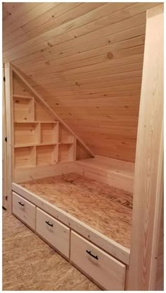 a loft bed with built in storage drawers and shelves underneath the roof is made out of plywood