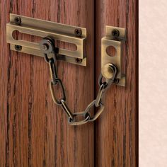 a close up of a wooden door with a lock and chain on the front handle