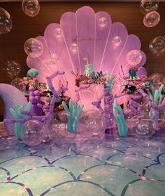 an elaborately decorated table with balloons and decorations