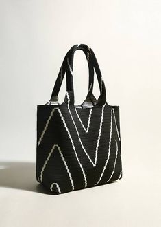 This luxurious black canvas tote bag features striking geometric stripes and a spacious interior, perfect for sophisticated women. Its elegant design elevates any outfit, making it a must-have for any fashion-forward individual. Carry all your essentials with ease in this beautifully crafted handbag. Size info 10 3/4" (35cm) width 10 3/8"(34cm) height 6"(15cm) depth Details Open top Top carry handles Polyester Item #462601 Women's tote bag Black Canvas Top Handle Shoulder Bag, Black Canvas Shoulder Bag With Top Handle, Trendy Black Top Handle Canvas Bag, Chic Black Canvas Bag For On-the-go, Elegant Black Canvas Bag With Double Handle, Elegant Black Canvas Shoulder Bag, Modern Black Canvas Bag For Everyday, Modern Black Canvas Bag For On-the-go, Chic Black Square Canvas Bag