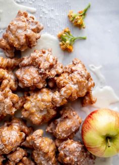 apples and walnuts are on a plate next to an apple