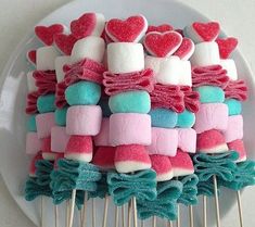 marshmallows are arranged on top of toothpicks in the shape of hearts