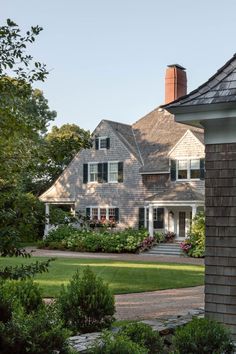 the house is surrounded by greenery and trees