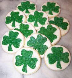 several decorated cookies with green shamrocks on them