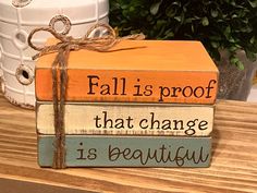 a stack of books with the words fall is proof that change is beautiful