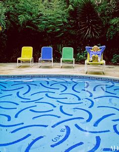 a pool with chairs next to it and an instagramr on the bottom right