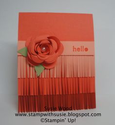 an orange and pink card with a flower on it