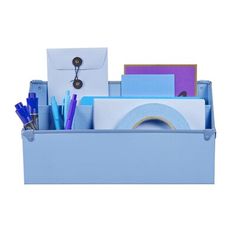 a blue box with various office supplies in it and a white envelope on the top