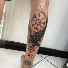 a person with a tattoo on their leg is holding onto a clock and compass wheel