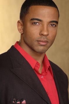 a man in a red shirt and black blazer