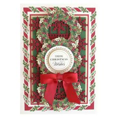 a christmas card with a red ribbon and wreath on the front that says, merry christmas wishes