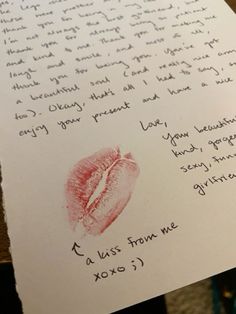 a handwritten letter with a red lipstick imprint on it and an image of a woman's lips