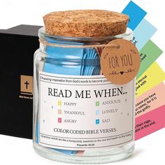 a glass jar filled with different colored paper and a cork top lid that says read me when