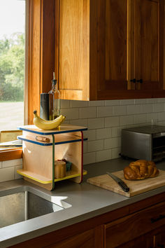 a kitchen counter topped with a loaf of bread and a banana on top of it