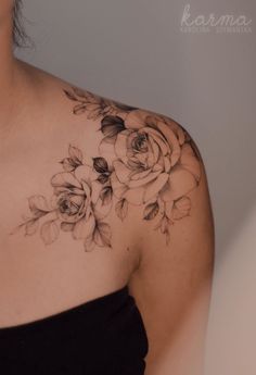 a woman's shoulder with flowers on it