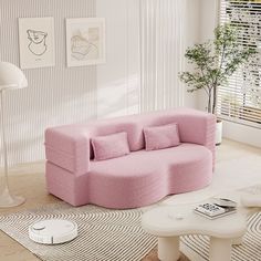 a living room with a pink couch and coffee table