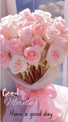 a bouquet of pink roses sitting on top of a table