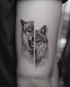 two wolf tattoos on the left thigh and one with an open mouth, both in black and white