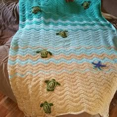 a crocheted blanket with sea shells on it is displayed in an instagramtion