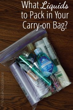 the contents of a carry - on bag sitting on top of a wooden table with text overlay