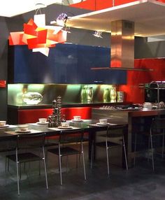 a modern kitchen with red and blue cabinets