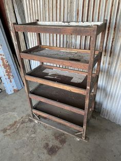 an old wooden shelf sitting in front of a corrugated wall