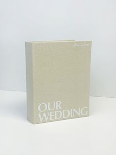 a white book with the words our wedding written on it's front and back cover