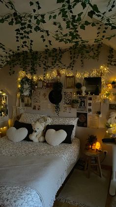 a bedroom decorated with lights and stuffed animals on the bed, along with other decorations