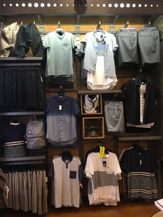 there are many different shirts on display in the store, including men's shirts