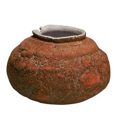 an old stone pot with a white lid