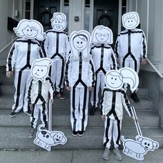 a group of people in costumes standing on steps with stickers around their heads and hands