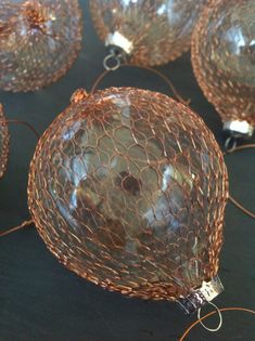 several wire wrapped ornaments on a table