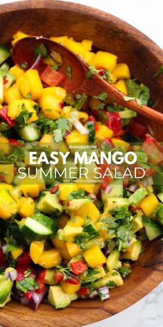 a salad in a wooden bowl with the title easy mango summer salad