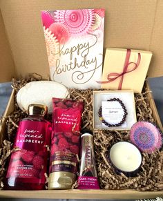 a birthday gift box with candles, soaps and other personal care items in it