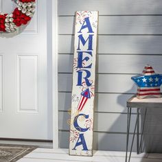 a wooden sign that says america with an american flag on it in front of a door