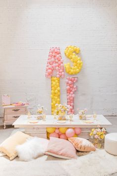 a table with balloons and decorations on it