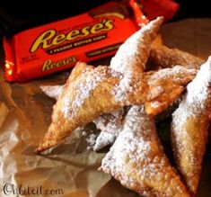 powdered sugar covered pastries and reese's candy bar are on the table