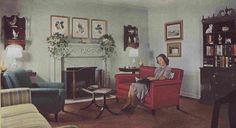 a woman sitting on a red chair in a living room