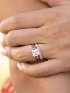 a woman's hand with a diamond ring on it