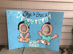 a cardboard sign with two babies on it