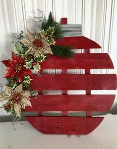 a wooden sign with poinsettis and greenery on it